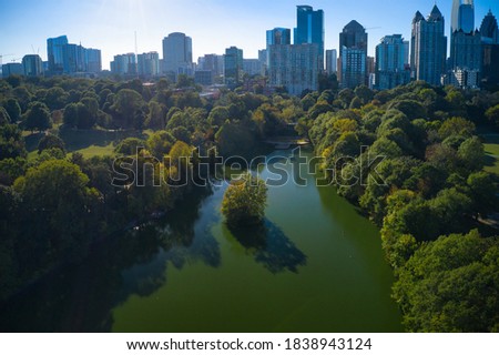Aerial drone shot of beautiful Piedmont park and lake Clara meer in downtown Atlanta taken on October 2020 during golden hour.