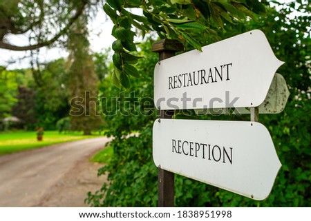 Restaurant and reception signs in botanic garden