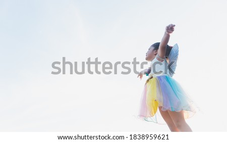 little girl flying, little girl in fairy costume, sky background
