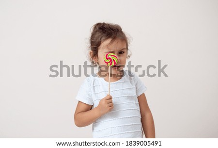 The small piece of paper on a bright background stands covered with a lollipop eye. Isolated.
