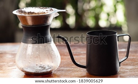 Drip coffee cup With ground coffee in the filter, Placed on a wooden table.