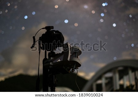 Take photos of the stars and milky way in the dark night sky.