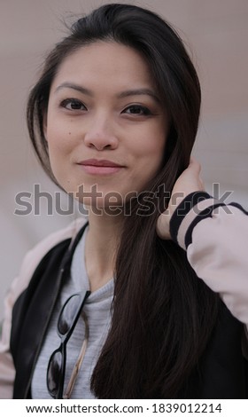 Young Asian woman poses for the camera in an urban area - people photography