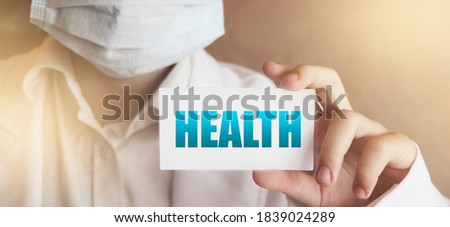 Health word card in hands of Medical Doctor.