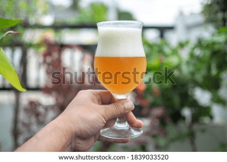 A man with a beer mug  With soft golden beer