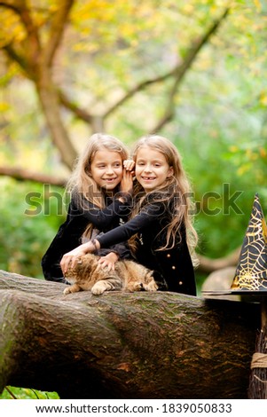 two girls dressed as witches in the park