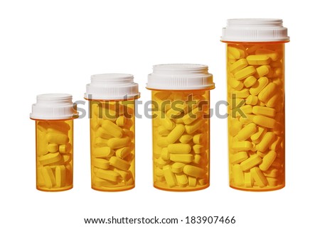 Bottles of pills arranged to represent a bar graph showing the rising cost of medicine and health care. Royalty-Free Stock Photo #183907466