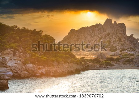 Dramatic sunset over sea and mounains, Sterna beach, Peloponessos, Greece