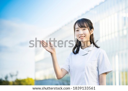 Woman in a white coat posing