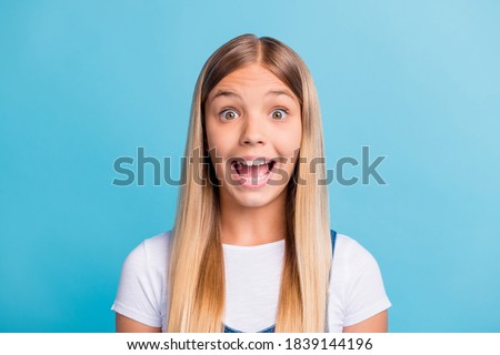 Photo portrait of surprised kid screaming isolated on pastel blue colored background
