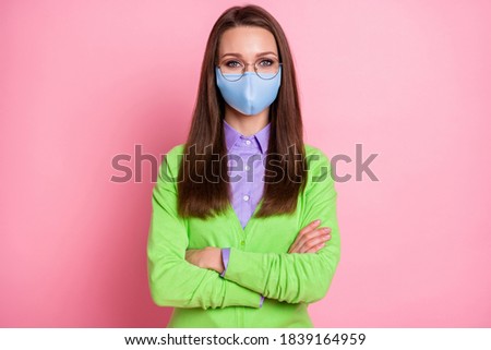 Portrait of nice attractive girl nerd geek folded arms wear medical mask isolated over pink pastel color background
