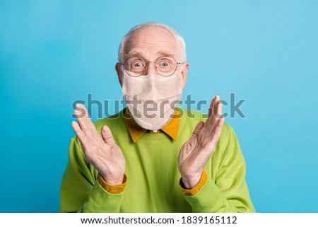 Photo of granddad raise palms wear white face mask isolated blue color background