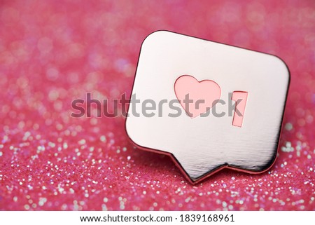 Like heart symbol. Like sign button, symbol with heart and one digit. Social media network marketing. Pink glitter sparks background.