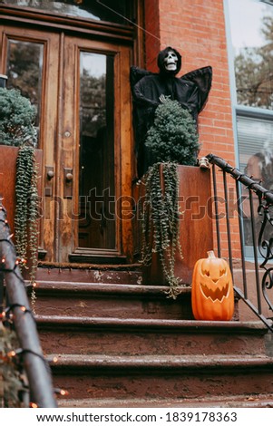 Small pumpkin adorns the porch of the house