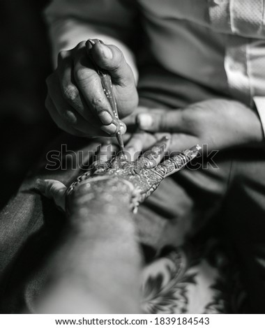 Henna is applied to the hands of a beautiful  Hindu Bride on her wedding.