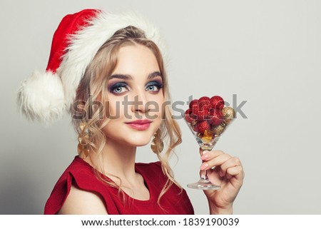 Christmas woman in Santa hat smiling on white background portrait