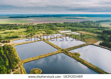 Aerial View Retention Basins, Wet Pond, Wet Detention Basin Or Stormwater Management Pond, Is An Artificial Pond With Vegetation Around The Perimeter, And Includes A Permanent Pool Of Water In Its Royalty-Free Stock Photo #1839205489