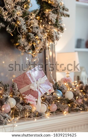Decor of a Christmas tree with gifts with a place for text with wooden houses in gentle colors.