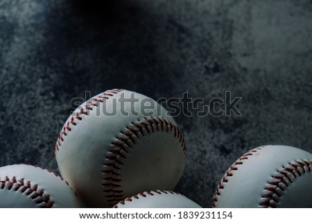 Baseballs close up with dark background for sport equipment.