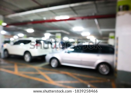 Abstract blurred car in parking background.