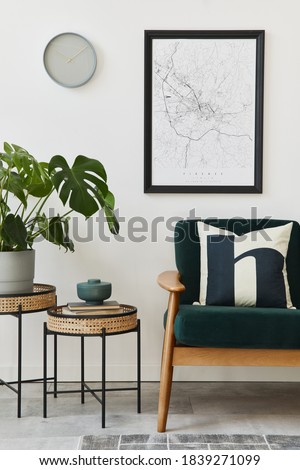 Modern retro concept of home interior with design green sofa, coffee tables, plants, mock up poster map, carpet and personal accessoreis. Stylish home decor of living room.
