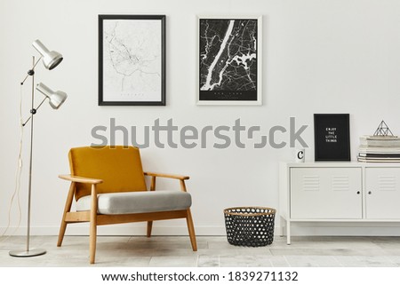 Retro and minimalist compositon of living room interior with design armchair, two mock up poster map, lamp, decoration, white wall and personal accessories. Template. Modern home decor.