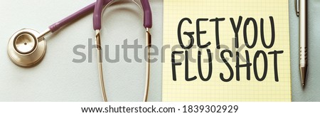 On a purple background a stethoscope with yellow list with text GET YOUR FLU SHOT