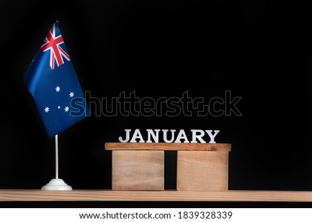 Wooden calendar of January with Australian flag on black background. Holidays of Australia in January.
