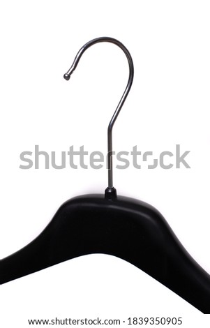 Black clothes hanger in the wardrobe white