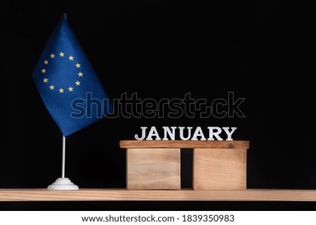 Wooden calendar of January with flag EU on black background. Holidays of European Union in January.
