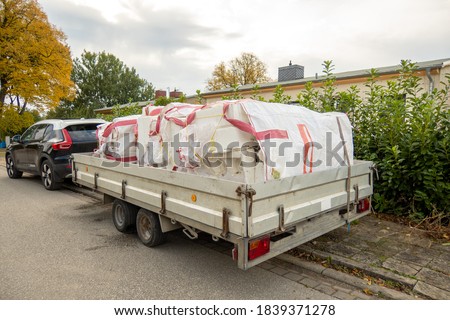 a car trailer is loaded with white bags