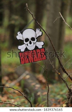 sign for halloween at nature with skeleton and red lettering, decorations