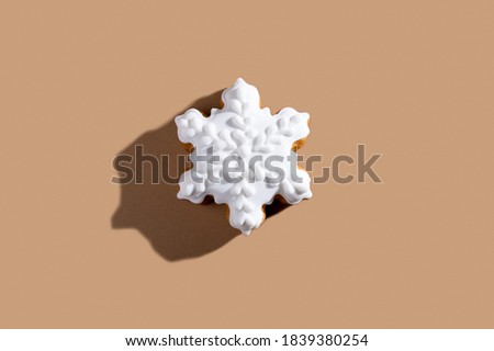Christmas pastry. Festive bakery. Winter holiday tradition. Homemade cookies. Gingerbread star figure biscuit white icing isolated on beige background.