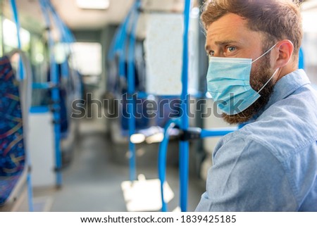 Profile of a man sitting in a bus and wearing a protective medical mask. Public transport during coronavirus covid-19 pandemic 