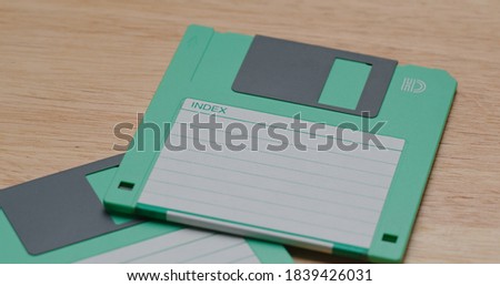 Two Green floppy disc on table
