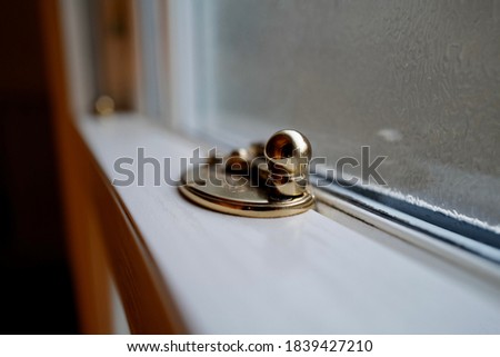 Gold Victorian sash window fasten Royalty-Free Stock Photo #1839427210
