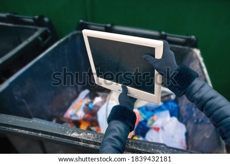 Woman rid old monitor, throw in trash can. User throwing away old monitor into garbage bin, broken device disposal. Concept of upgrading hardware and updating old technologies