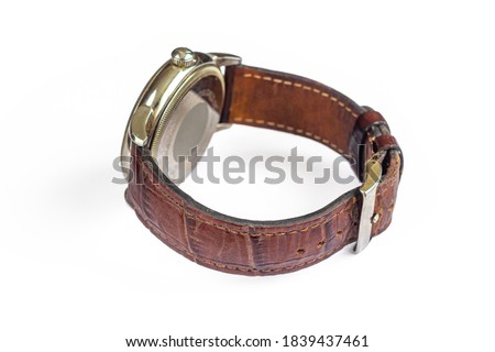 Mechanical watch with an old, worn, leather strap, isolated on a white background