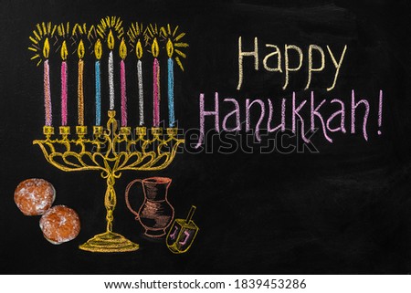 Menorah, dreidel and sufganiyot on chalkboard. Hanukkah holiday illustration. View from above.