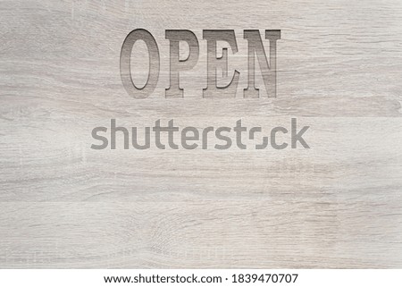 Label open on wood background