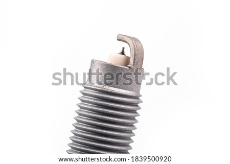 Studio lighting. spark plug from a gasoline engine. It is matte. Close-up