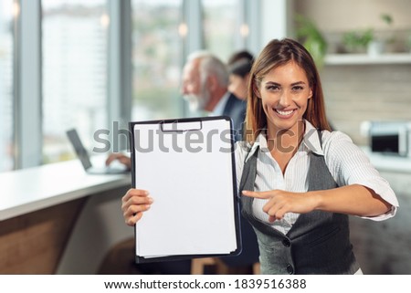 Business woman hold white blank paper. Young smiling.