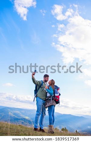 Happy Couple On A Hike Taking A Selfie