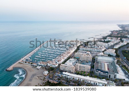Aerial perspective of "Puerto Banus" Bay in Marbella, Spain. Luxury travel destination famous for expensive lifestyle and shopping area. Exclusive restaurants. Luxury yacht. Sunset. Beautiful sky