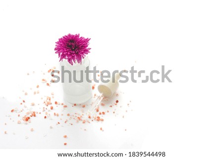 Pink flower in a bottle with a pipette. Isolated