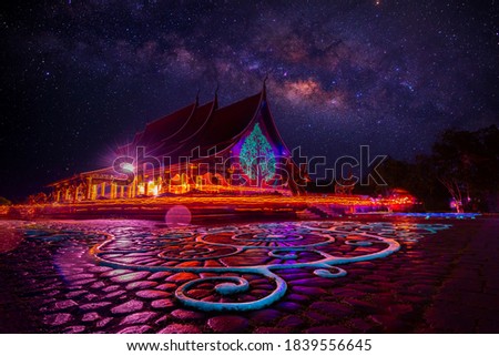 Amazing Temple Sirindhorn Wararam Phuproud in Ubon Ratchathani Province at night time,Thailand.Thai temple with grain and select white balance.Night sky effect for Long exposure fluorescent light.