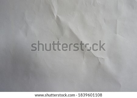 Plain white wrinkled paper with space for text for an artistic background.