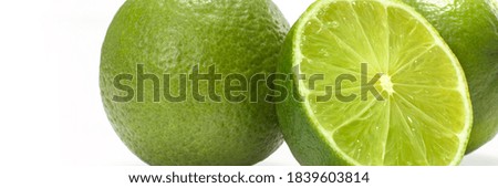 Food banner concept, organic fruits and ingredients: close up of organic limes isolated on white background