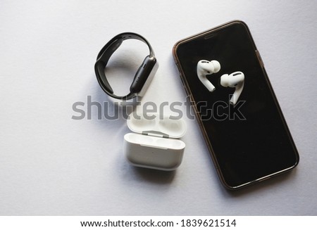 Flat lay shot of gadgets and mobile devices in white background.  Royalty-Free Stock Photo #1839621514