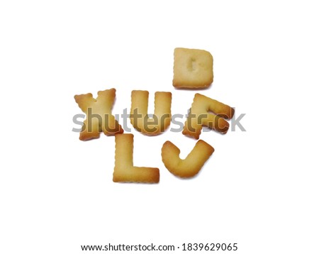 English alphabet shaped biscuits isolated on white background, selective focus.